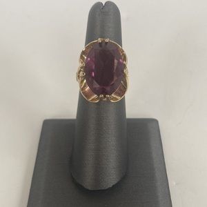 Z58- Costume jewelry- Gold colored ring with a purple stone.